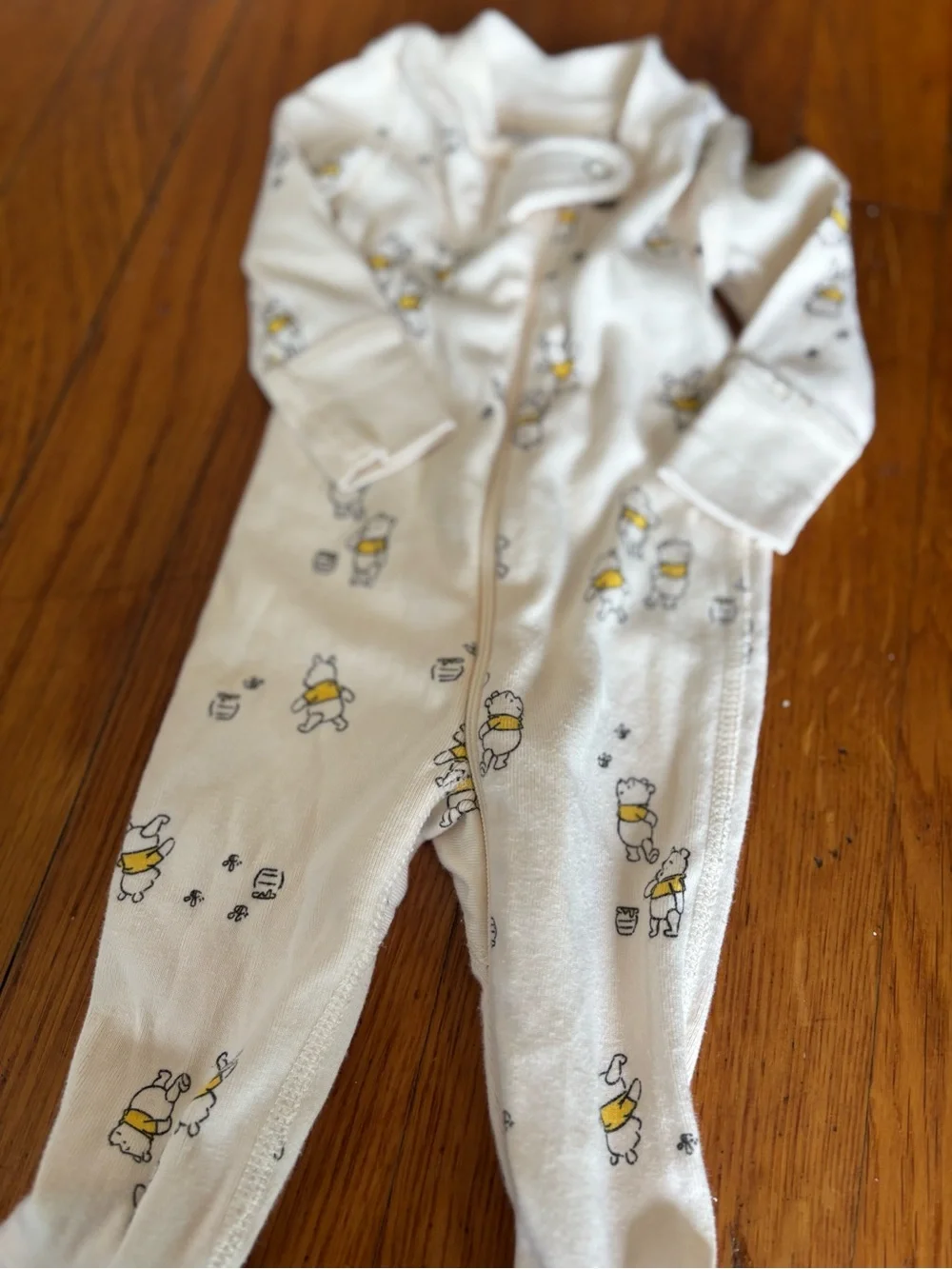 Hanna Andersson Cream Footed One-Piece with Winnie the Pooh.
